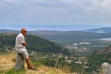 Naklejka na ściany i meble Senior hiking the beautiful mountains of Montenegro