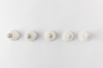 top view of badminton shuttlecocks in row on white surface