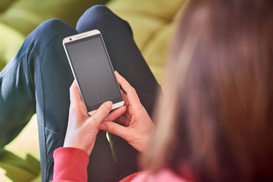 Woman holding blank smart phone screen