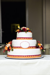 White new beautiful colorful wedding cake in three tiers