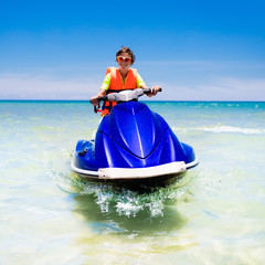 Teenager on jet ski. Teen age boy water skiing.