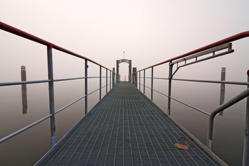 Ferry berth on the lake, on a foggy winter day.