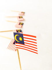 Set of toothpick with a small paper flag of Malaysia. Lined up and decorated on isolated white background. Bendera Malaysia, Flag.