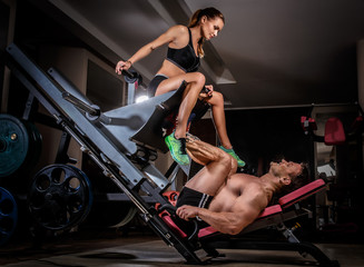 Fototapeta na wymiar Sports couple is working out at gym.