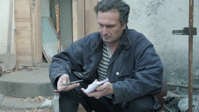A man holding a knife and money. Preparing the attempt on the life of. Doubt and conscience 4K