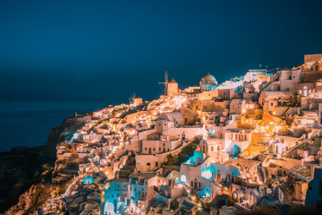 Santorini Oia Greece during vacation with a view at the white washed village with beautiful greek...