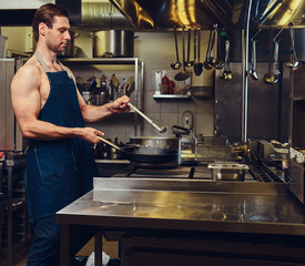 The chef preparing meat on a dry pan.