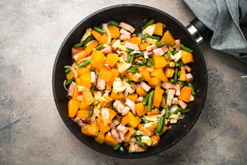 Pumpkin fried with vegetables and bacon. 
