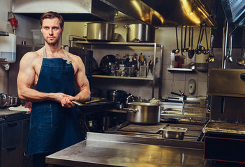 The chef holds dry pan.