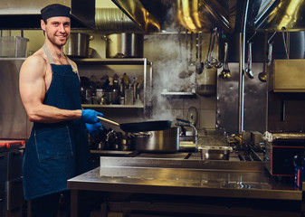 The chef holds dry pan.