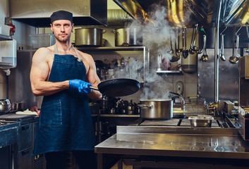 The chef holds dry pan.