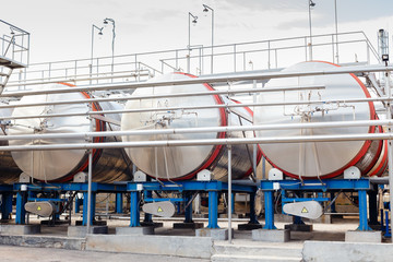 Modern technological industrial equipment of wine factory. Large stainless steel wine distilling...