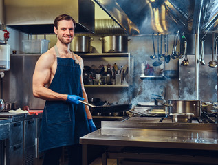 The chef holds dry pan.