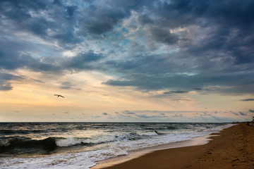 Naklejka na ściany i meble Dramatic sky on a morning seascape. Storm on a sandy sea beach.