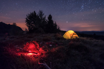Fototapeta na wymiar iluminated tend and campfire