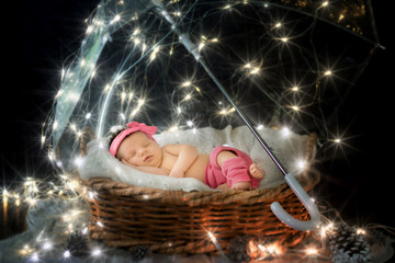 Portrait of a newborn child under a fairy umbrella with stars