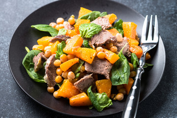Warm salad with pumpkin, baked beef, spinach and chickpeas.