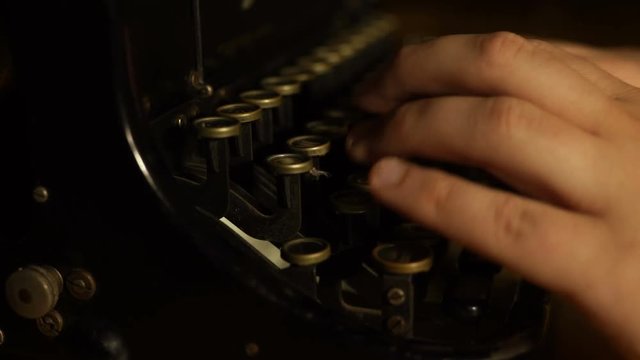 Close-up of old typewriter with hands tapping and sound