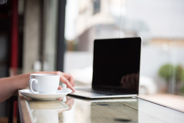 hot coffee cup near a computer on the counter bar illustrate relax and working concept