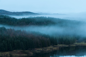 Fototapeta na wymiar Mist over Mudle / Mist over the woodland at Loch Mudle, Ardnamurchan in Lochaber, Scotland. 25 December 2017.