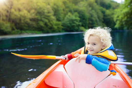 Child on kayak. Kids on canoe. Summer camping.