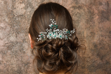 Image from back of brunette with hairdo and diadem