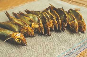 Smoked herring fish. Delicious smoked fish on the burlap.
