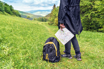 tourist girl with map and backpack