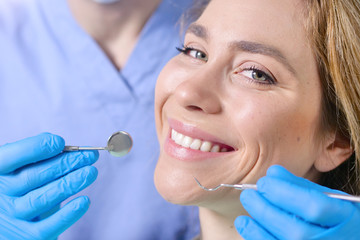 In a professional practice, a dentist checks the dentition of the patient, and she is happy with...