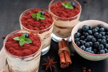 tiramisu luxury dessert in a glass with mint on a black background