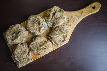 Cutlets on a cutting board.