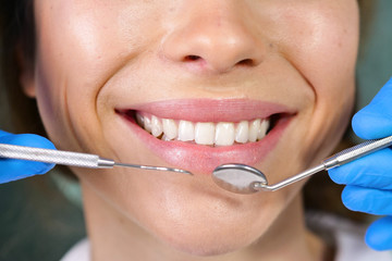 In a professional practice, a dentist checks the dentition of the patient, and she is happy with...