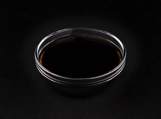 Soy sauce on black background