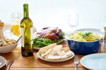 bottle of wine and food on served wooden table