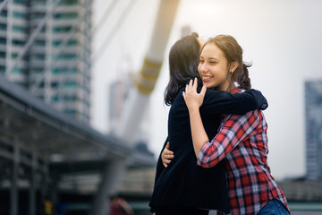 Joyful mother and daughter hug together after mother back form travel