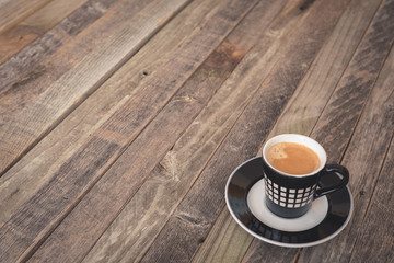Single small coffee cup on wooden background