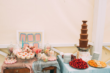 Sweet table with berries, fruits and with guest lists.