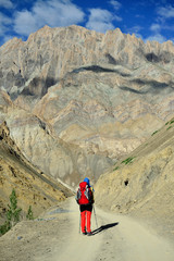 Traveller on the trekking on Markha valley trek route in Ladakh, Karakorum panorama. This region is a purpose of motorcycle expeditions