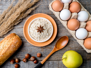 Ingredients for Breakfast Oatmeal Eggs Bread Apple Rustic Wooden background