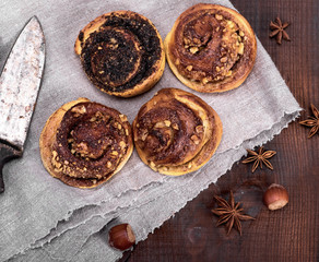 round buns with cinnamon and poppies on a gray textile napkin