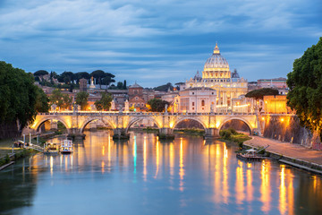Sunset view of St. Peters Basilica in the Vatican and the Ponte Sant'Angelo, Bridge of Angels, at...