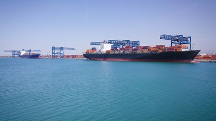 View of an industrial port where freight loads are carried for national and international shipping by sea or ocean on cargo ships. Concept of: transportation, ships, trade.