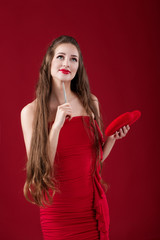 Fototapeta premium woman writes with pen on red heart.