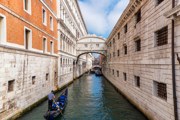 Fototapeta na wymiar Gondolas floating on canal towards Bridge of Sighs (Ponte dei Sospiri). Venice, Italy