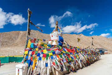 White Tibet style pagoda and Prayer flags at Khardungla Pass, the highest motorable pass in the world, ladakh, Jammu and Kashmir, India