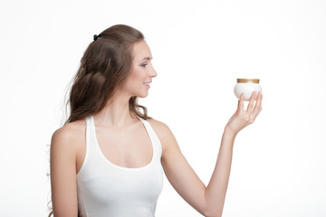 woman holding jar of cream