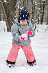 Fototapeta na wymiar Small kid making snowball