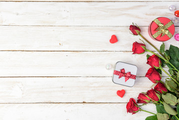 Red roses and gift box on old white wood table/Valentines day background with copy space