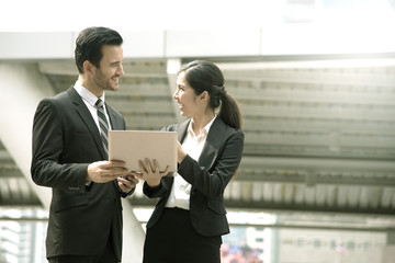 Businessman and businesswoman partner consulting and discussing at outdoor.