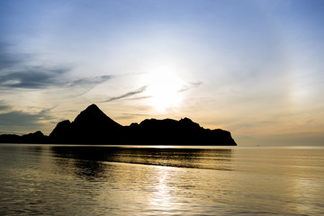 Fototapeta premium Landscape of a big mountain a long the sea during sun rise background.